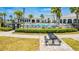 Community pool with lounge chairs, umbrellas, picnic table, manicured landscape and a black metal fence at 14250 Sapelo Beach Dr, Orlando, FL 32827