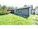Backyard of a house with an open lawn, covered patio, and some shrubs at 1460 Spring Ridge Cir, Winter Garden, FL 34787
