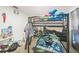 Untidy bedroom with a black metal bunk bed and lots of toys and personal items at 1460 Spring Ridge Cir, Winter Garden, FL 34787