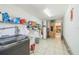 Bright laundry room with tiled floors, storage shelves and cabinets, and a washer and dryer at 1460 Spring Ridge Cir, Winter Garden, FL 34787
