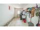 Bright laundry room with tiled floors, storage shelves and a utility sink at 1460 Spring Ridge Cir, Winter Garden, FL 34787