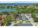 A beautiful aerial view of a residential home nestled in a community with a lake in the Walt Disney World area at 14835 Old Thicket Trce, Winter Garden, FL 34787