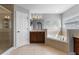 Bright bathroom with a glass shower enclosure, tub with tile surround, and vanity with storage at 14835 Old Thicket Trce, Winter Garden, FL 34787