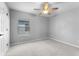 Bright bedroom with plush carpeting, window with blinds, and door to the side at 14835 Old Thicket Trce, Winter Garden, FL 34787