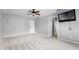 Large bedroom with ceiling fan, wall mounted TV, and walk in closet at 14835 Old Thicket Trce, Winter Garden, FL 34787