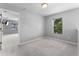 Bright, carpeted bedroom featuring a large window and neutral paint at 14835 Old Thicket Trce, Winter Garden, FL 34787