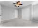 A bedroom with carpet flooring, ceiling fan, closet, and door at 14835 Old Thicket Trce, Winter Garden, FL 34787