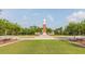 Exterior day view of the community clock tower with a well-maintained lawn and landscaping at 14835 Old Thicket Trce, Winter Garden, FL 34787