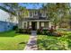 Charming two-story home with beautiful landscaping, green lawn and brick walkway at 14835 Old Thicket Trce, Winter Garden, FL 34787