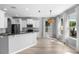 Bright open kitchen featuring white cabinets, stainless appliances, and a breakfast bar overlooking the dining area at 14835 Old Thicket Trce, Winter Garden, FL 34787