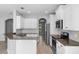 Well-equipped kitchen with granite countertops, stainless steel appliances, and white cabinetry at 14835 Old Thicket Trce, Winter Garden, FL 34787