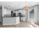 Stylish kitchen with white cabinets, granite countertops, and modern appliances at 14835 Old Thicket Trce, Winter Garden, FL 34787