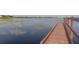 Scenic view of a serene lake from a wooden dock, showcasing the tranquil waters at 14835 Old Thicket Trce, Winter Garden, FL 34787