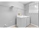 A laundry room equipped with a washer and dryer and a wire shelving unit at 14835 Old Thicket Trce, Winter Garden, FL 34787