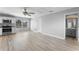 Spacious living area with hardwood flooring, kitchen, and bathroom at 14835 Old Thicket Trce, Winter Garden, FL 34787