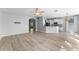 Open-concept living space with hardwood floors, modern lighting, and a breakfast bar at 14835 Old Thicket Trce, Winter Garden, FL 34787