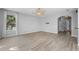 Bright living room with hardwood floors, a ceiling fan, and ample natural light at 14835 Old Thicket Trce, Winter Garden, FL 34787