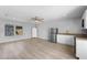 View of living space with kitchen, stainless appliances, and hardwood flooring at 14835 Old Thicket Trce, Winter Garden, FL 34787