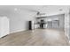 Open-concept living room, kitchen featuring stainless steel appliances and hardwood floors at 14835 Old Thicket Trce, Winter Garden, FL 34787