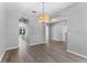 Open concept space with sleek hardwood floors, neutral paint, and arched doorways at 14835 Old Thicket Trce, Winter Garden, FL 34787