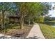 Picturesque walking path by the lake, featuring a gazebo surrounded by trees and greenery at 14835 Old Thicket Trce, Winter Garden, FL 34787