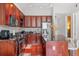 Well-appointed kitchen with wooden cabinets, granite counters, stainless appliances, and a central island at 150 E Robinson St # 16B-2 1605, Orlando, FL 32801