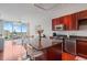 Modern kitchen featuring a granite island, cherry cabinets, and stainless steel appliances at 150 E Robinson St # 16B-2 1605, Orlando, FL 32801