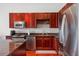 Well-equipped kitchen featuring dark wood cabinetry, granite countertops, and stainless steel appliances at 150 E Robinson St # 16B-2 1605, Orlando, FL 32801