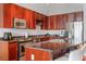 Modern kitchen featuring dark wood cabinetry, granite countertops, and stainless steel appliances at 150 E Robinson St # 16B-2 1605, Orlando, FL 32801