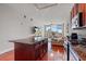 Open-concept living space boasts a gourmet kitchen island, and a comfortable living room with balcony access and views at 150 E Robinson St # 16B-2 1605, Orlando, FL 32801