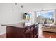 The open living space has a gourmet kitchen island, a comfortable living room with balcony access and beautiful views at 150 E Robinson St # 16B-2 1605, Orlando, FL 32801