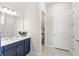 Bathroom with a double vanity, modern lighting, and a separate toilet room for added convenience at 15049 Canopy Cover Dr, Winter Garden, FL 34787