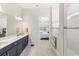 Bright bathroom with dual sinks, white countertops and a tiled walk-in shower at 15049 Canopy Cover Dr, Winter Garden, FL 34787