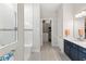 Bathroom featuring dual sinks, a walk-in shower, and access to a walk-in closet at 15049 Canopy Cover Dr, Winter Garden, FL 34787