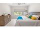 Bright bedroom with a large window, neutral walls, and coastal-themed decor at 15049 Canopy Cover Dr, Winter Garden, FL 34787