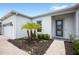 Inviting front entrance with lush landscaping, walkway, and a modern glass front door at 15049 Canopy Cover Dr, Winter Garden, FL 34787