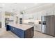 Modern kitchen featuring white cabinets, a large island, and stainless steel appliances at 15049 Canopy Cover Dr, Winter Garden, FL 34787