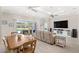 Open floor plan boasts living room, dining area and a view of the backyard and pool at 15049 Canopy Cover Dr, Winter Garden, FL 34787