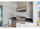 A built-in stainless steel grill and sink offers an outdoor cooking experience on the covered patio at 15049 Canopy Cover Dr, Winter Garden, FL 34787