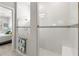 Walk-in shower with white tile, glass enclosure, and decorative accent tiles at 15049 Canopy Cover Dr, Winter Garden, FL 34787