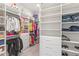 Spacious walk-in closet with custom shelving and ample storage space at 15049 Canopy Cover Dr, Winter Garden, FL 34787
