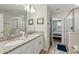 Bright bathroom with double vanity, granite counters, and a glass shower at 1520 Mulligan Blvd, Davenport, FL 33896
