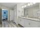 Bright bathroom features a double sink vanity with granite countertops and stylish tile flooring at 1520 Mulligan Blvd, Davenport, FL 33896