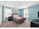 Comfortable bedroom with light blue walls, two windows, and a well-made bed, creating a cozy retreat at 1520 Mulligan Blvd, Davenport, FL 33896