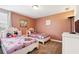 Charming bedroom with two beds adorned with cartoon bedding, creating a fun and inviting space at 1520 Mulligan Blvd, Davenport, FL 33896