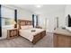 Comfortable bedroom features carpet floors, wood furniture, and a cozy bed with adjacent ensuite bathroom at 1520 Mulligan Blvd, Davenport, FL 33896