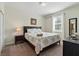 This cozy bedroom features a bedside table, dark wood furnishings, and comfortable bed at 1520 Mulligan Blvd, Davenport, FL 33896