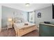 Serene bedroom with a detailed bed frame and decorative artwork, designed for peaceful relaxation at 1520 Mulligan Blvd, Davenport, FL 33896