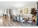 Elegant dining room with large table, chandelier, and staircase access at 1520 Mulligan Blvd, Davenport, FL 33896