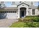 Inviting home entrance with well-manicured landscaping and a paver driveway at 1520 Mulligan Blvd, Davenport, FL 33896